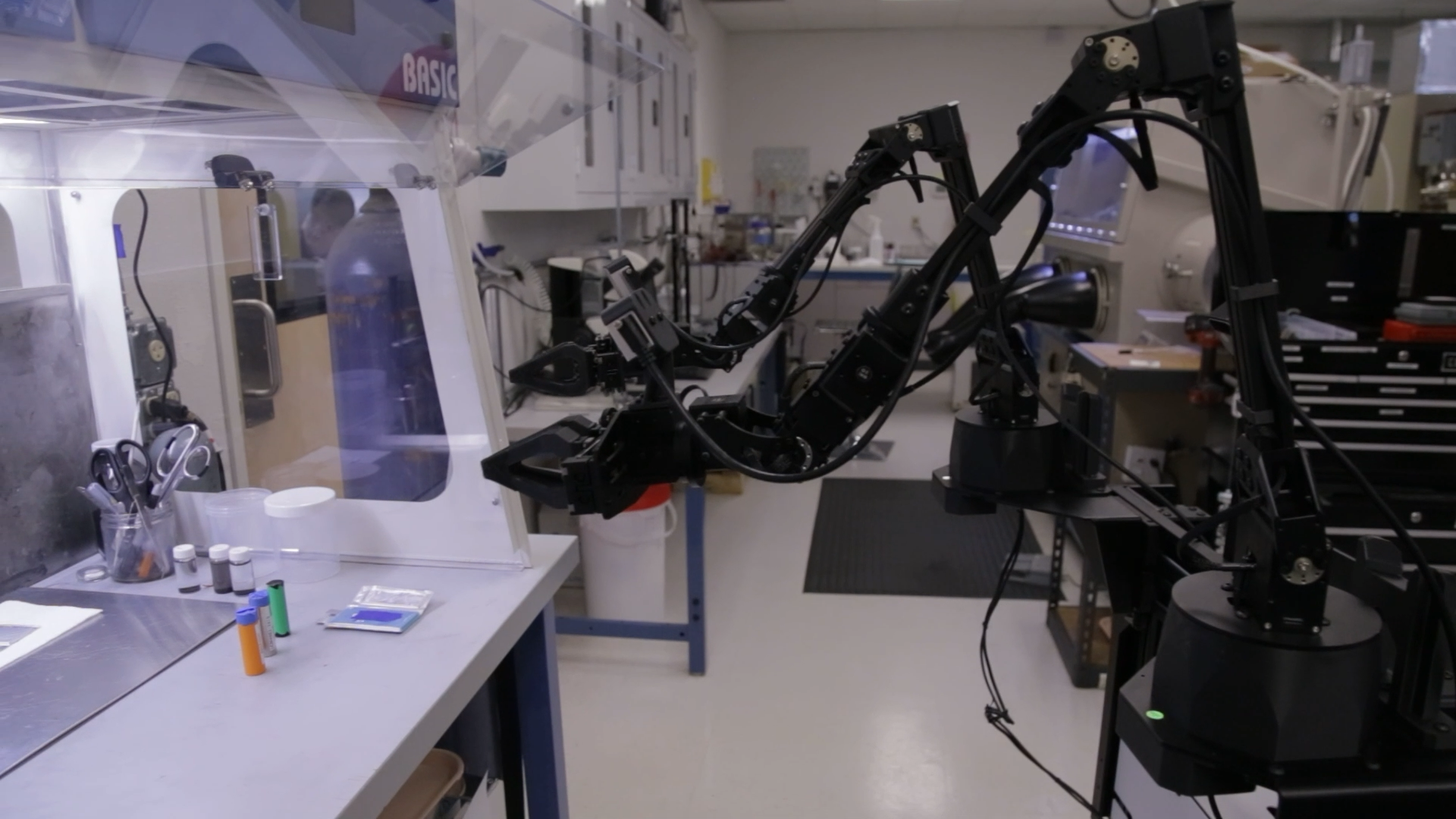 Robot arm operating inside a glovebox enclosure